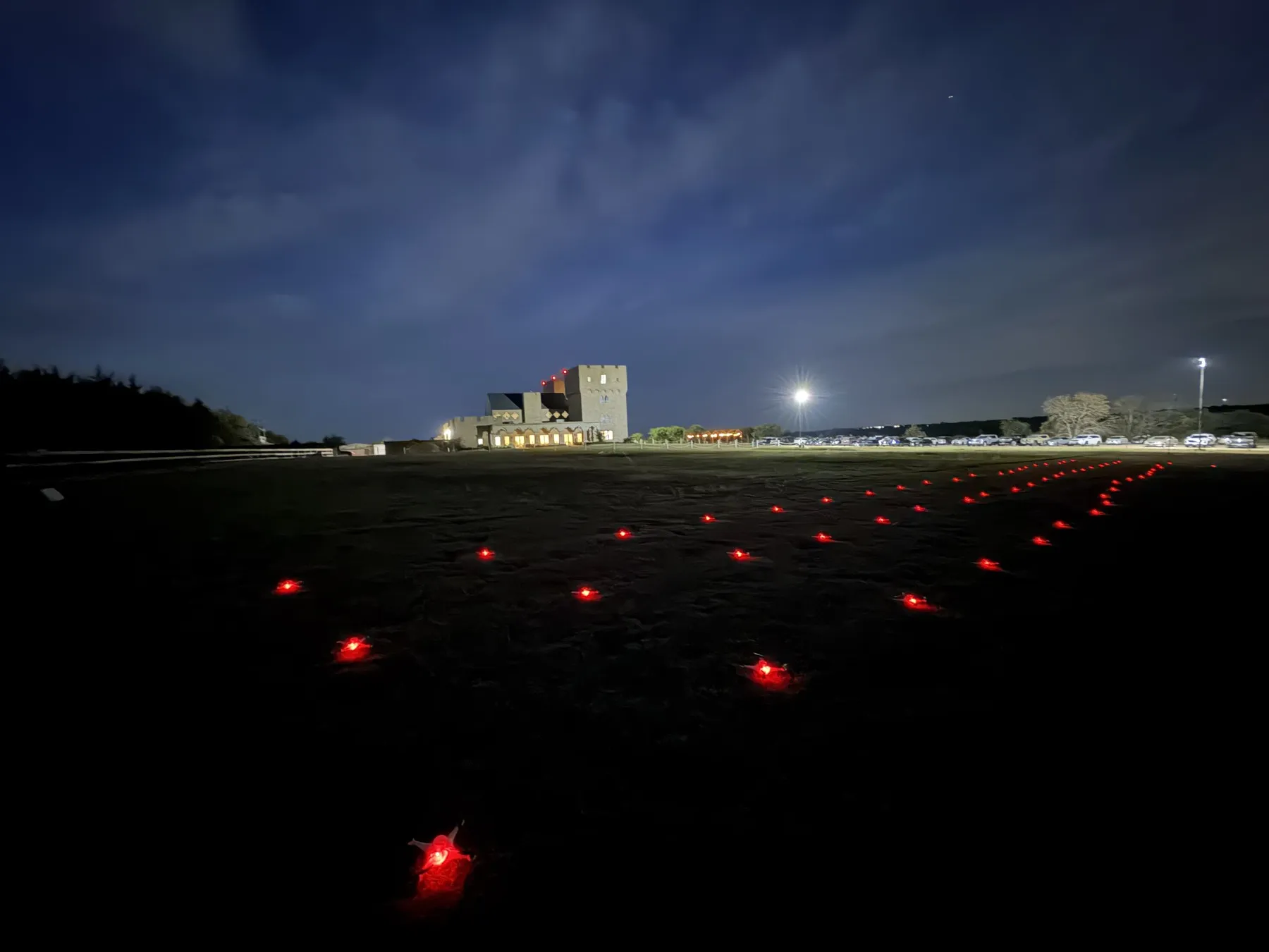Red-lit drones staged on the lawn before a wedding show at The Castle at Rockwall